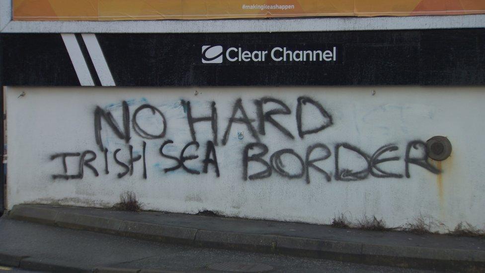 Wall graffiti which reads 'No hard Irish Sea border'