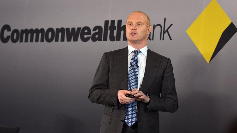 Commonwealth bank head Ian Narev in front of bank logo