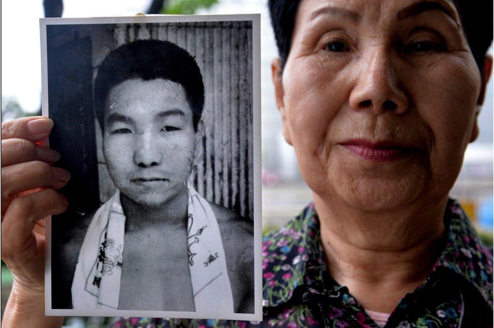 Hideko Hakamada, sister of former boxer Iwao Hakamada who has been on death row in Japan for 47 years, shows a picture of her young brother Iwao during an interview outside the Tokyo Detention House in Tokyo on May 20, 2013.