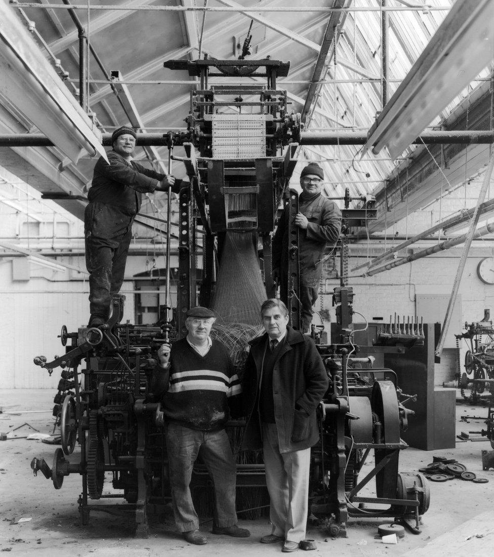 Men on a loom