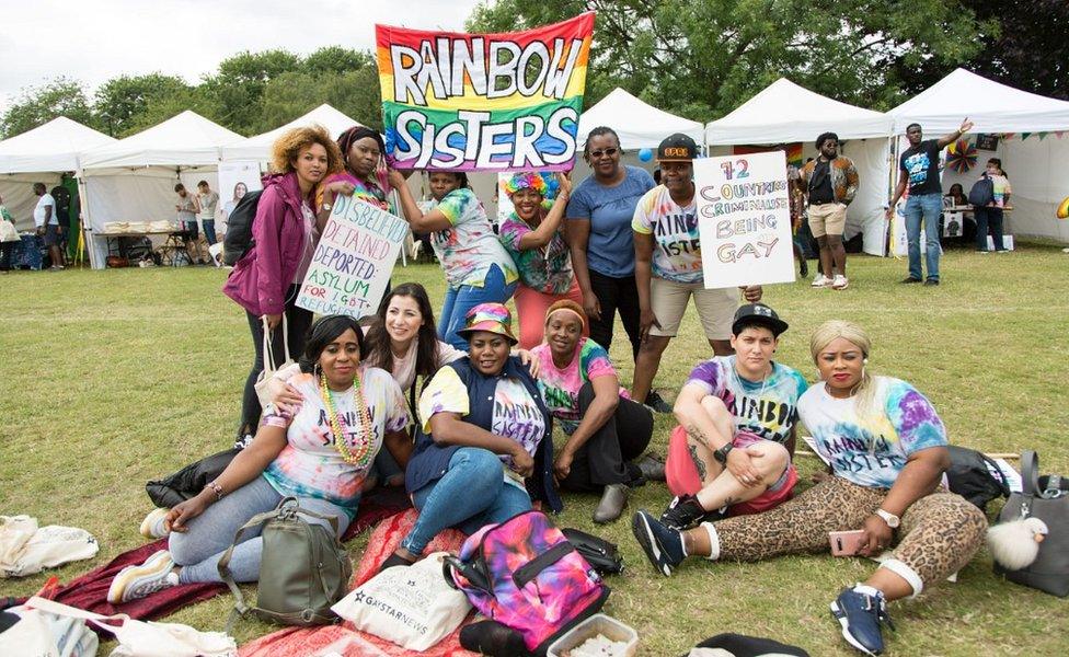 People posing with placards at UK Black Pride 2019