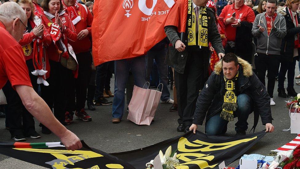 Borussia Dortmund fan shows his respect at Anfield Memorial during the memorial service marking the 25th anniversary of the Hillsborough Disaster, at Anfield Stadium on April 15, 2016 in Liverpool,