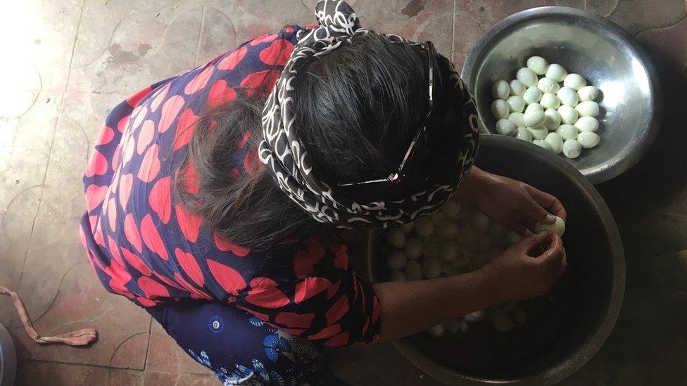 Girl peels eggs