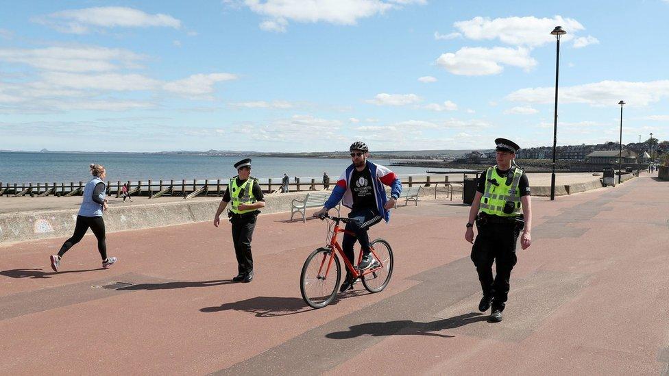 Police officers patrol the beach front at Portobello on Sunday