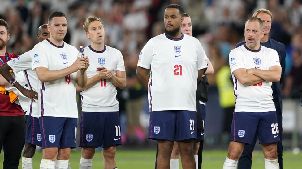 England players, left to right, Stewart Downing, Russell Howard, Chunkz and Joe Cole look on during penalty shoot-out during the Soccer Aid for UNICEF match