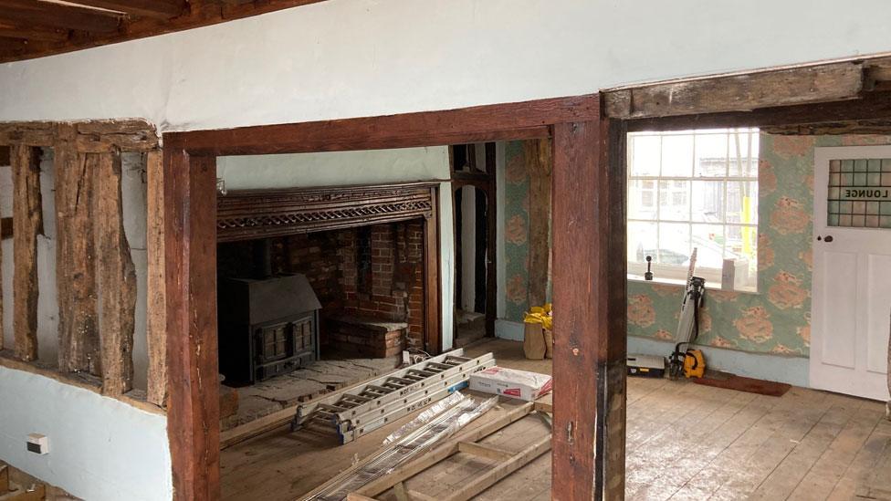 Inside The Red Lion, with the view of a fireplace and exposed beams