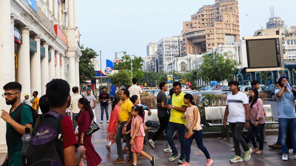 People shop at a crowded market place at Connaught Place- the commercial business district, on the eve of World Population Day in New Delhi, India on July 10, 2022. World Population Day is an annual event, observed on July 11 every year, which seeks to raise awareness of global population issues