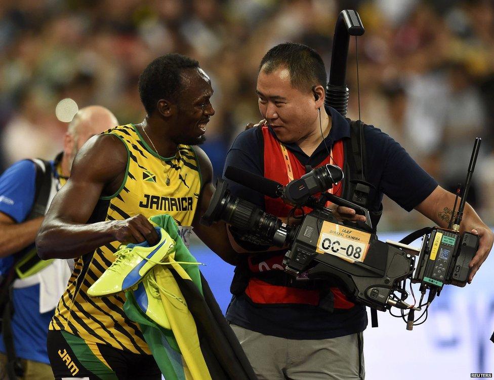 Usain Bolt of Jamaica chats with a cameraman after winning the men"s 200m final during the 15th IAAF World Championships at the National Stadium in Beijing, China 27 August 2015