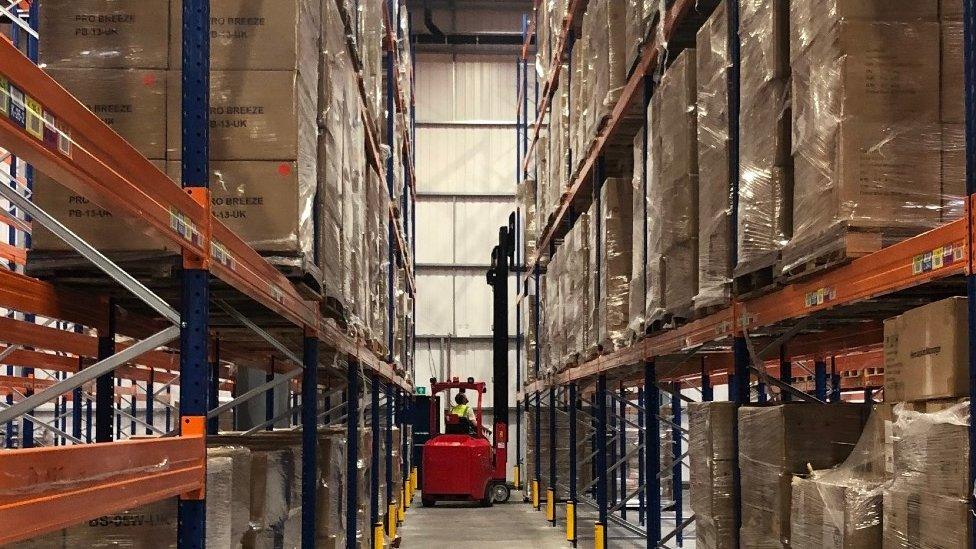 Boxes stocked high in a warehouse