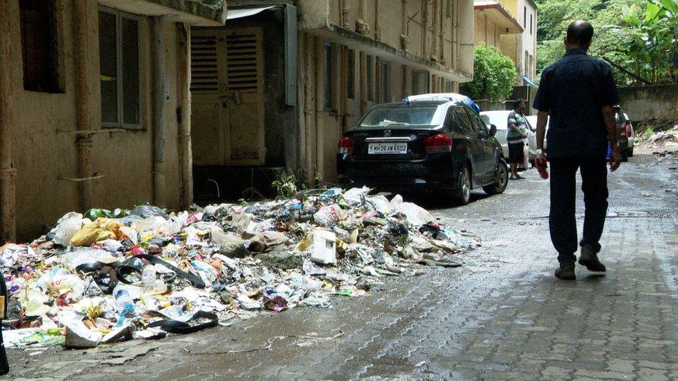 A pile of rubbish alongside houses in Mahul