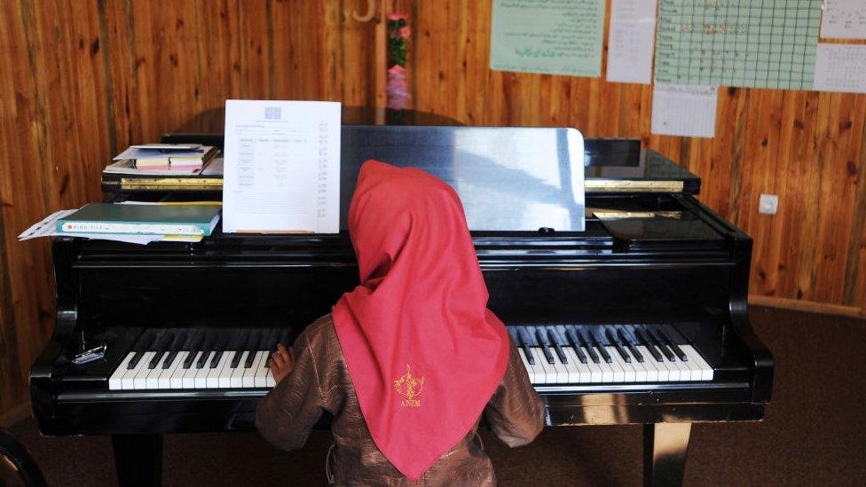 A young girl plays the piano in a music class in the Afghan National Institute of Music on October 19, 2011 in Kabul, Afghanistan.