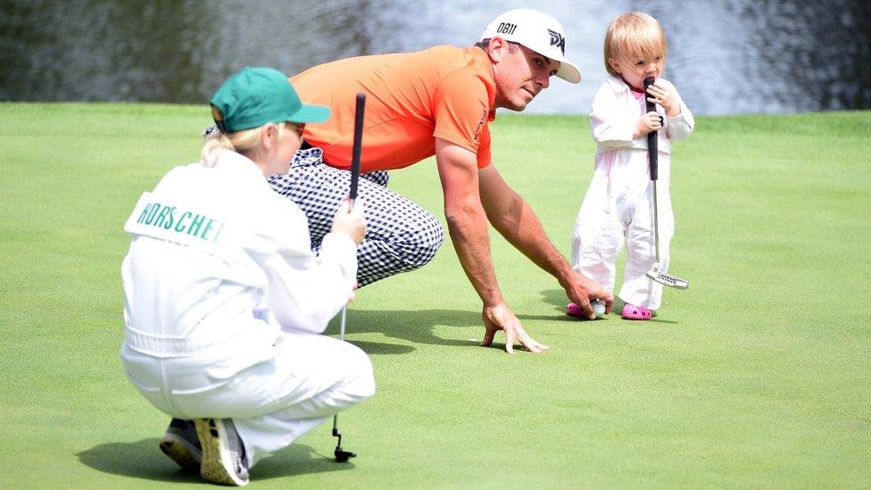 Billy Horschel of the United States plays with his daughter Skylar as wife Brittany looks on during the Par 3 Contest prior to the start of the 2016 Masters Tournament at Augusta National Golf Club on April 6, 2016