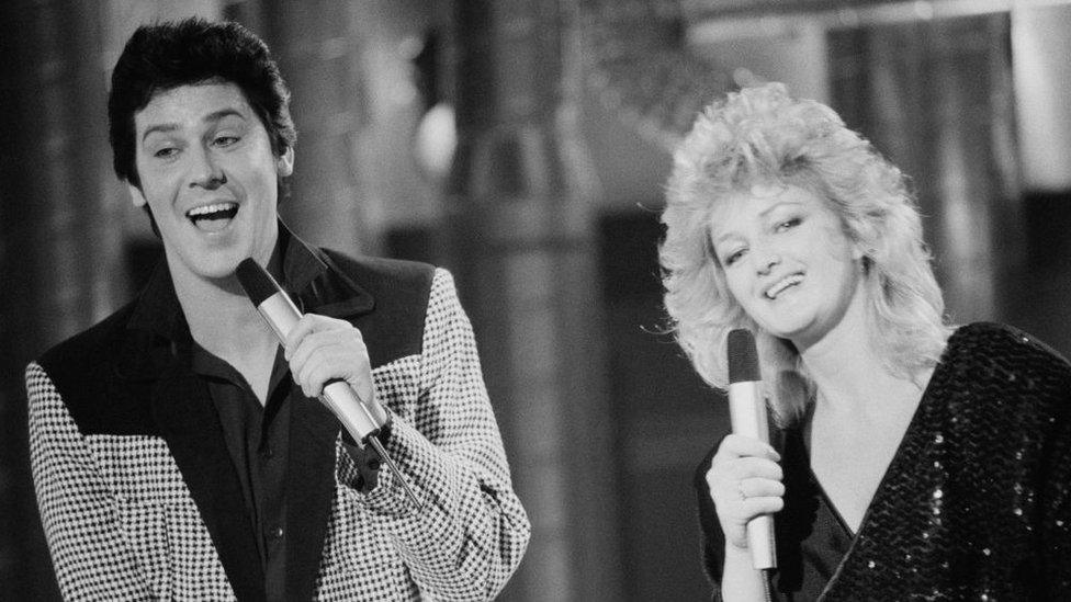 Welsh singer Shakin' Stevens and Bonnie Tyler performing at the Channel 4 Christmas Show, UK, 12th December 1983