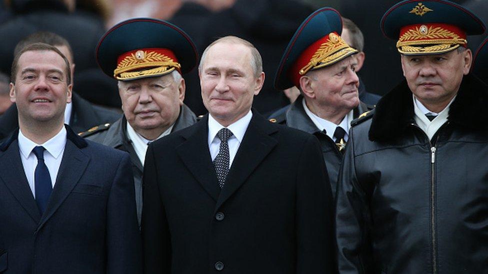 Vladimir Putin (C) talks to Defence Minister Sergei Shoigu (2nd R) Dmitry Medvedev