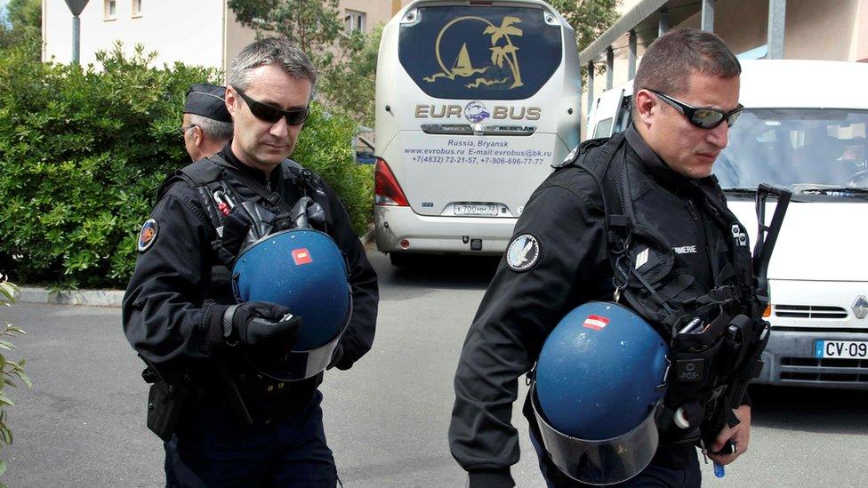 French police pass a Russian fan bus in Mandelieu near Cannes, 14 June