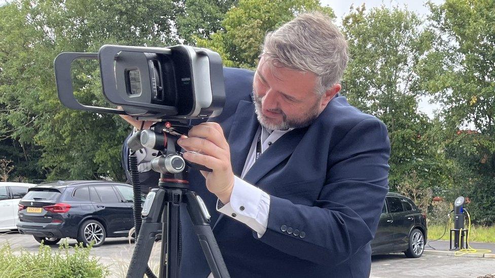 A man setting up a Fujifilm Xair ultraportable X-ray machine