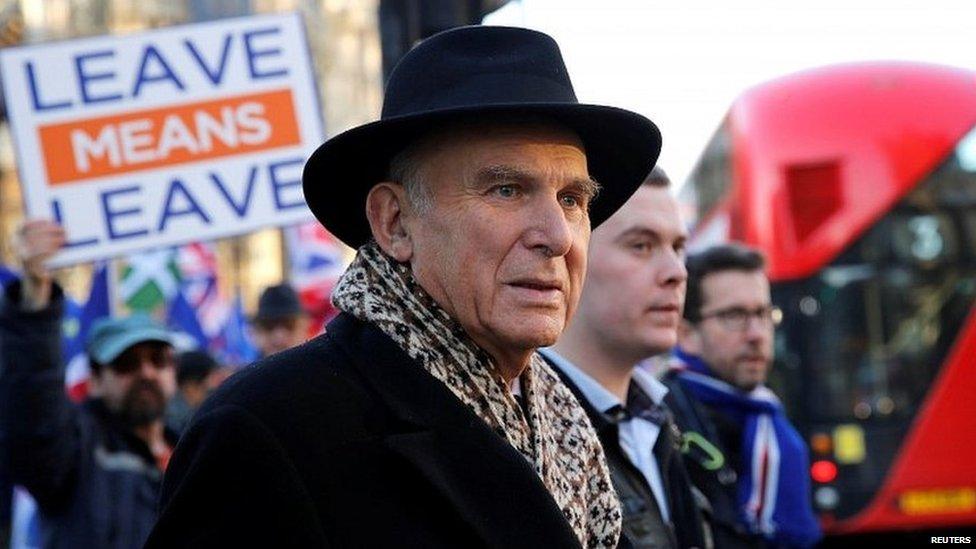 Sir Vince Cable, with a Brexit supporter in the background