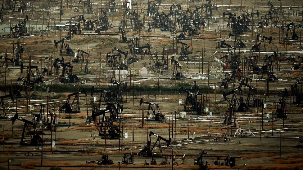 A general view shows oil pumping jacks and drilling pads at the Kern River Oil Field in Bakersfield, California on July 28, 2015.