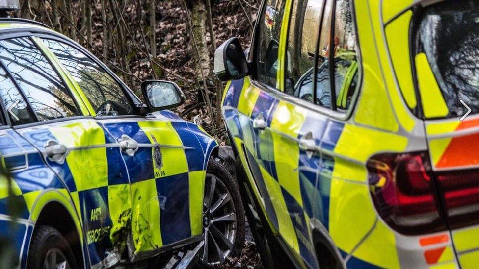 Two police cars damaged in a collision