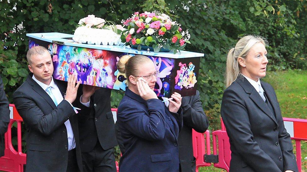 coffin going into church