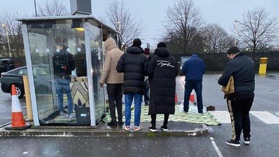 Drivers praying at bus stop