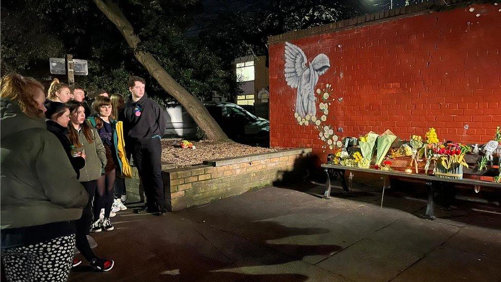 Vigil at memorial bench