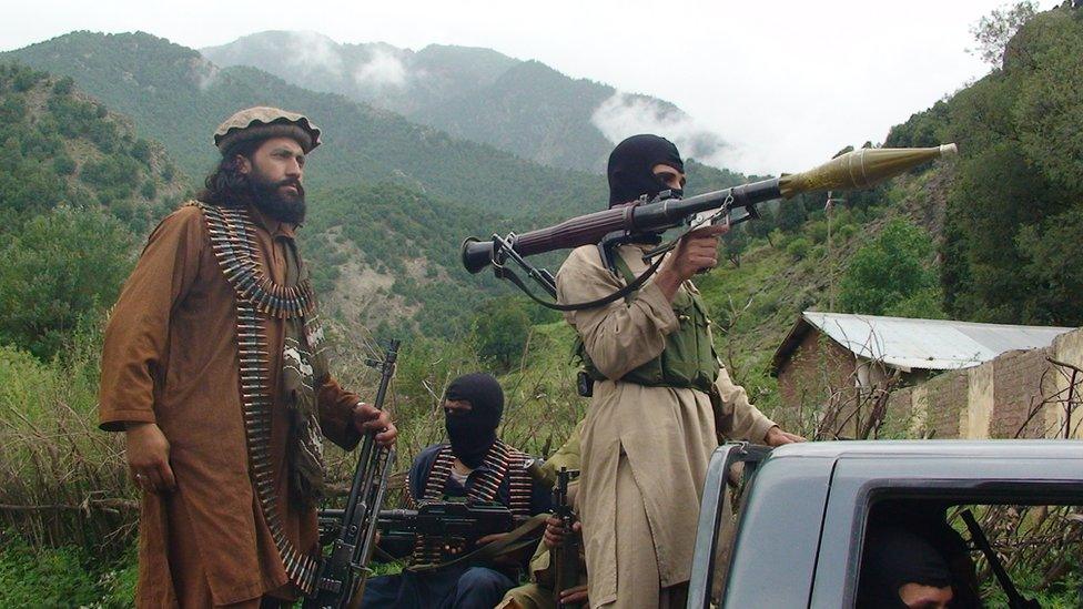 file photo taken on Sunday, Aug. 5, 2012, Pakistani Taliban patrol in Shawal in Pakistani tribal region of South Waziristan