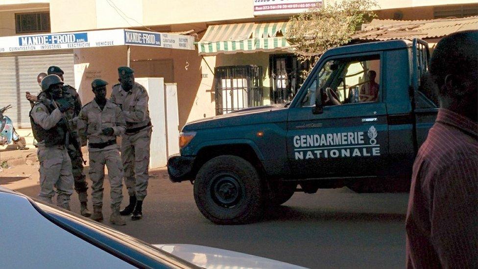 Security forces gather near the Radisson Hotel in Bamako, Mali.