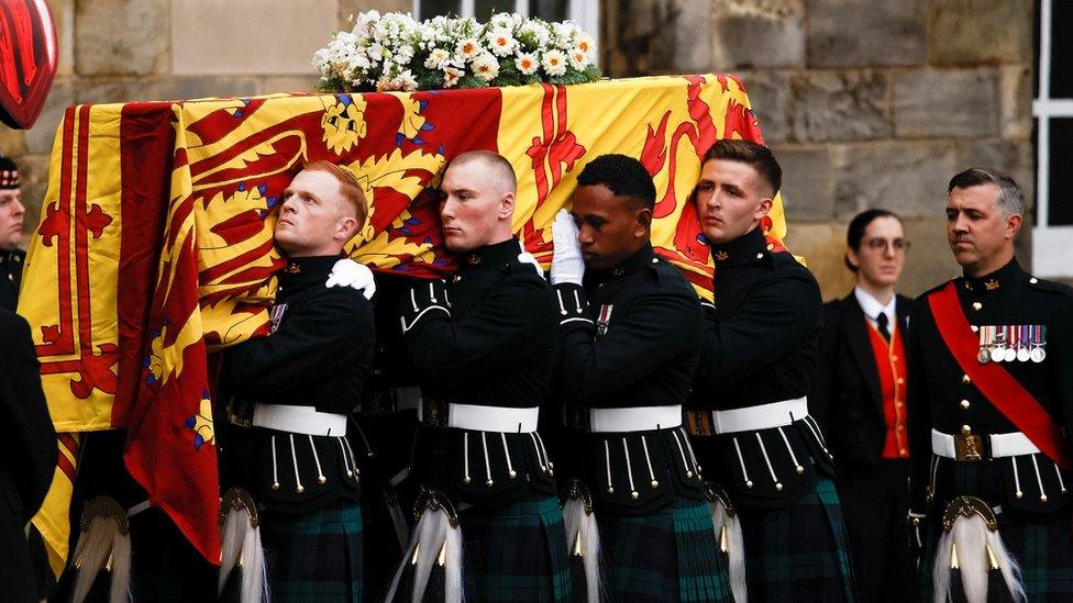 Soldiers carry the Queen's coffin