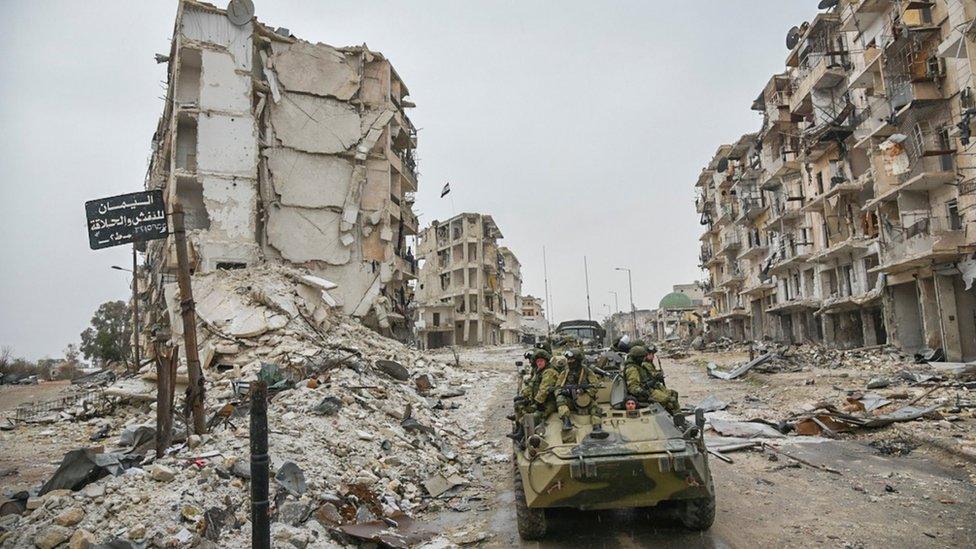 An undated handout photo from the Russian military appears to show Russian troops in an armoured vehicle in Aleppo, Syria