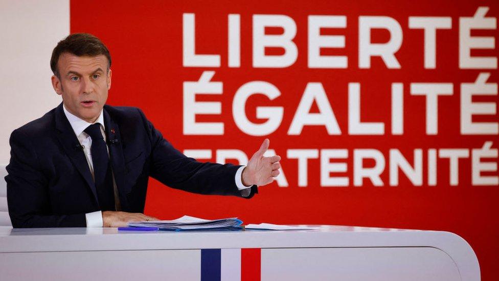 France's President Emmanuel Macron gestures as he speaks during a press conference to present the course for France's newly appointed government