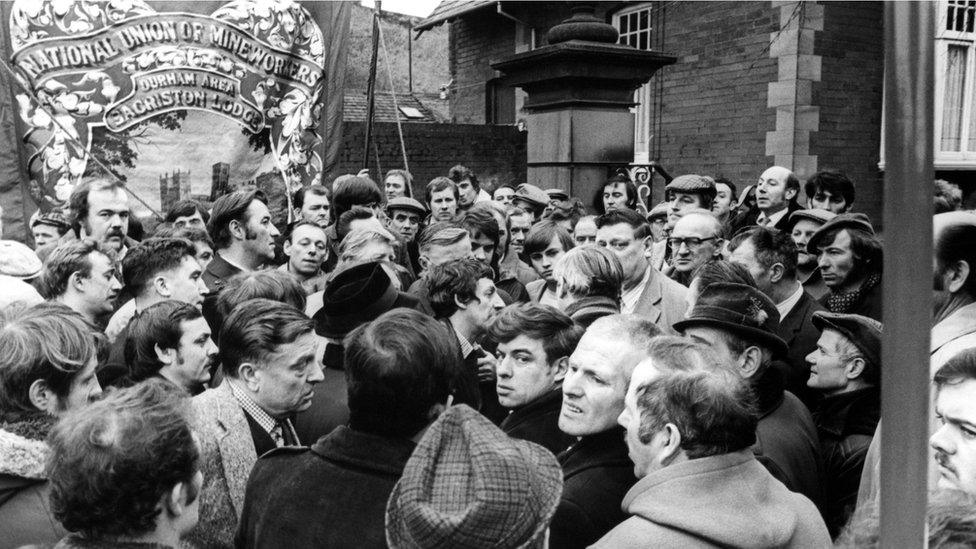 Striking miners and banner