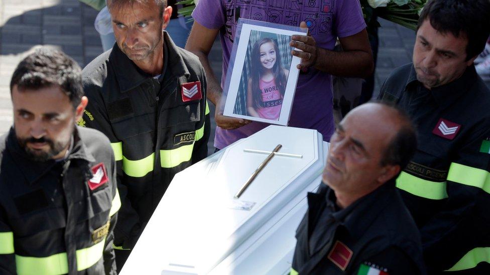 The coffin of Giulia is carried outside the gymnasium at the end of the state funeral service in Ascoli Piceno.