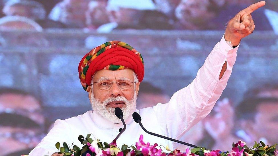 This handout photograph released by India"s Press Information Bureau (PIB) on March 4, 2019, shows Indian Prime Minister Narendra Modi addressing a gathering during during the inauguration of various development projects in Jamnagar, in the Indian state of Gujarat.