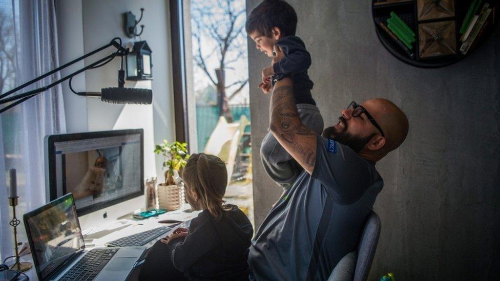 Hungarian DJ Lotfi Begi (R) and his children chat with one of the grandparents via Skype during their self-isolation at their home in Torokbalint, Hungary, 07 April 2020