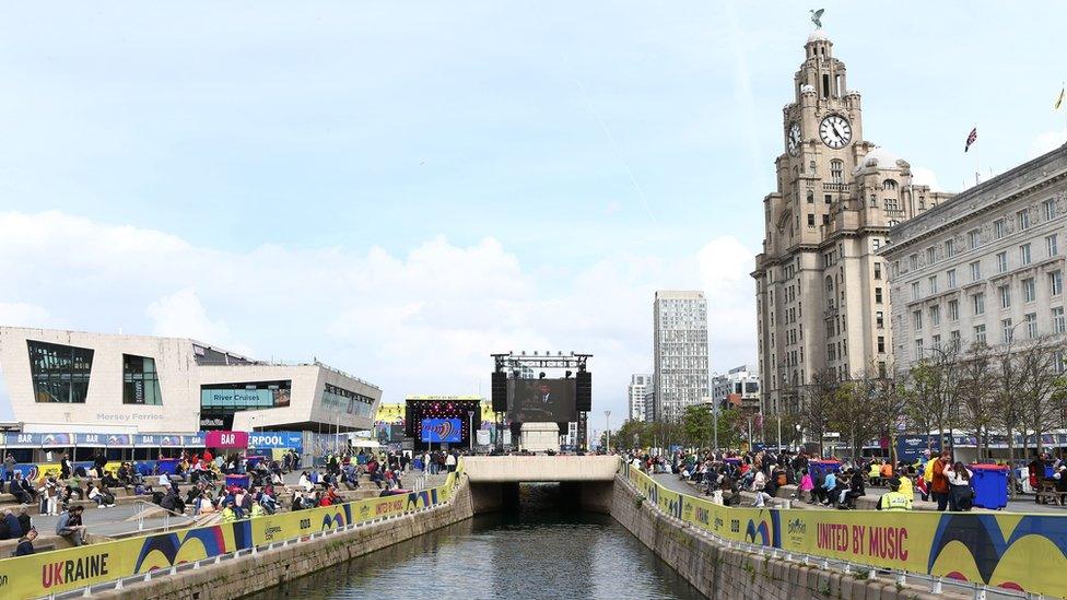 People watch the Coronation on a big screen in Liverpool