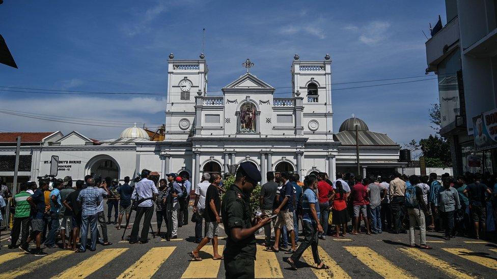 Local residents gather outside the St. Anthony"s Shrine in Colombo on April 22, 2019,