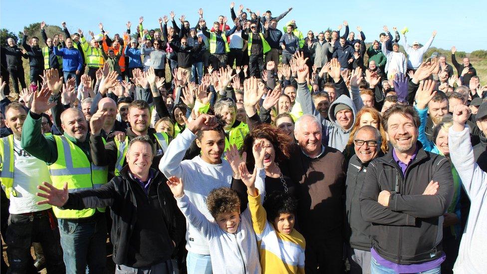 The Smedley family with Nick Knowles and a crowd of volunteers