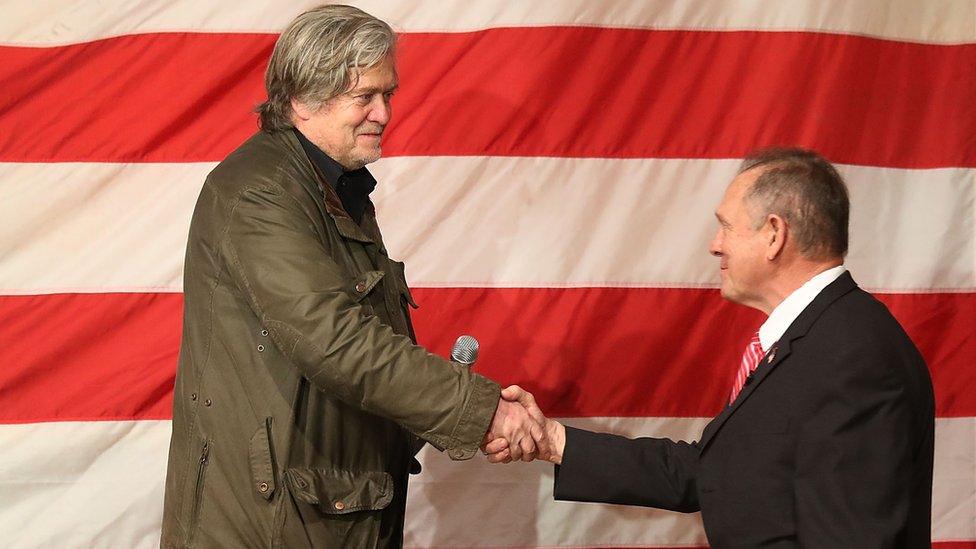 Steve Bannon shakes hands with Roy Moore at an election-eve rally in Alabama.