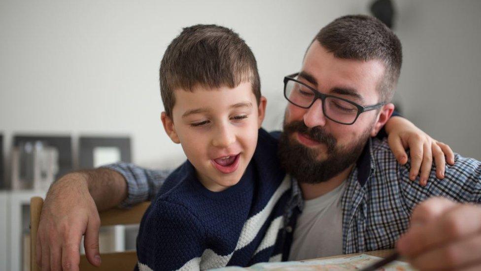 Dad helps son with homework