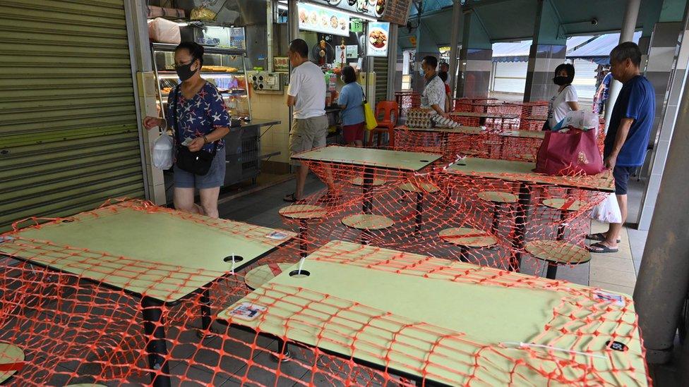 Cordoned off tables at a food court in Singapore