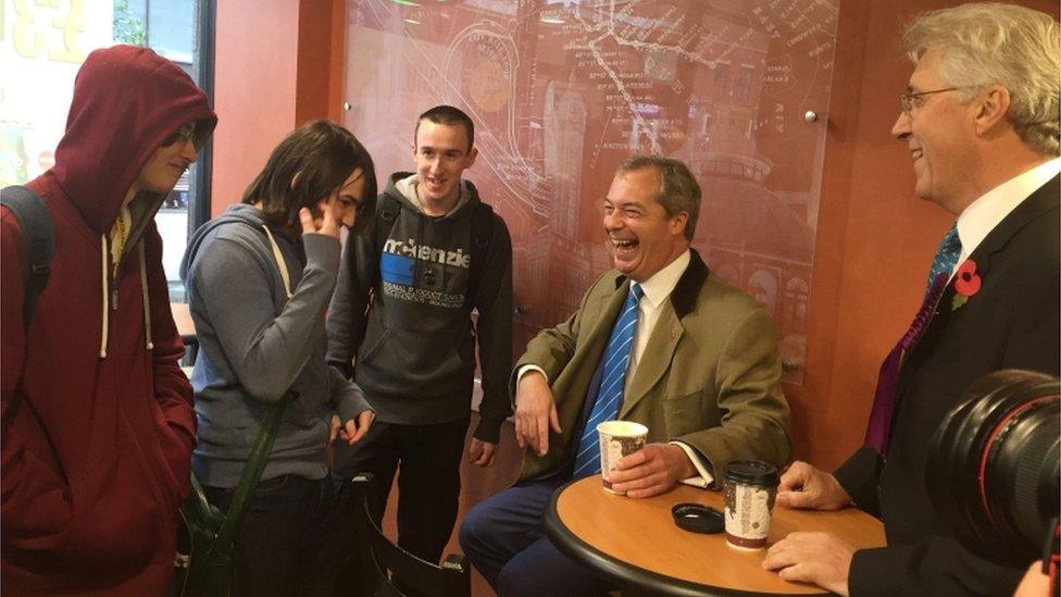 UKIP leader Nigel Farage talks to locals as he visits a Subway store in Yorkshire Street in Oldham while on the campaign trail for the upcoming Oldham West and Royton by-election