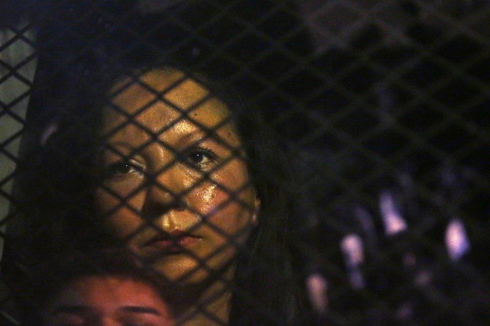 Guadalupe Garcia de Rayos is locked in a van that is stopped in the street by protesters outside the Immigration and Customs Enforcement facility in Phoenix, Arizona, 8 February