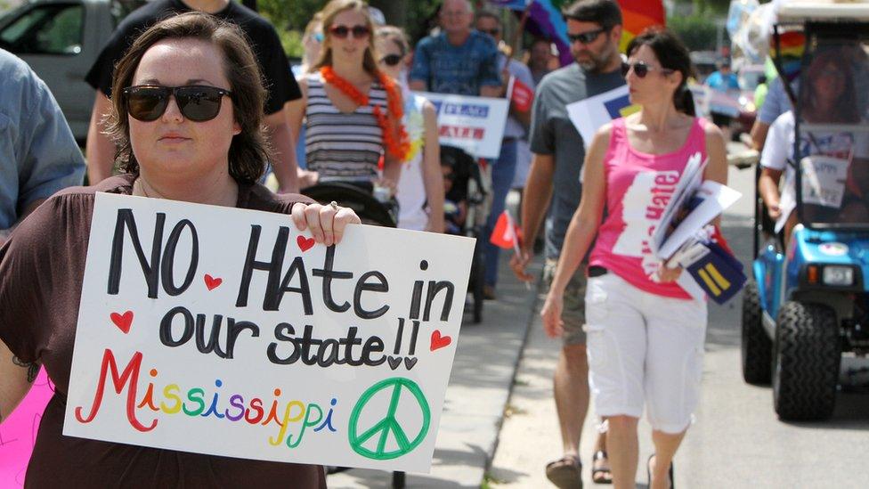 Protesters in St. Louis, Mississippi rally against a law they say discriminates against the LGBT community.