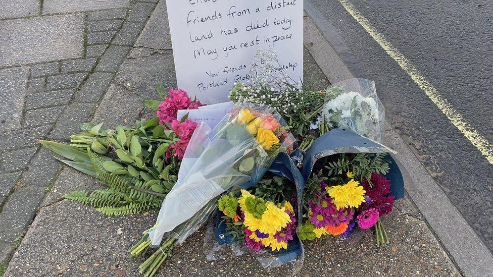 Flowers left at entrance to Bibby Stockholm