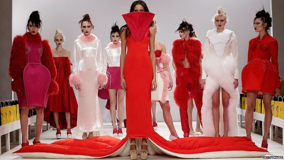 A model in a huge red outfit at London fashion week