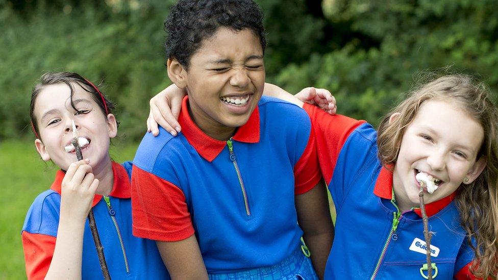 Three Girl Guides laughing