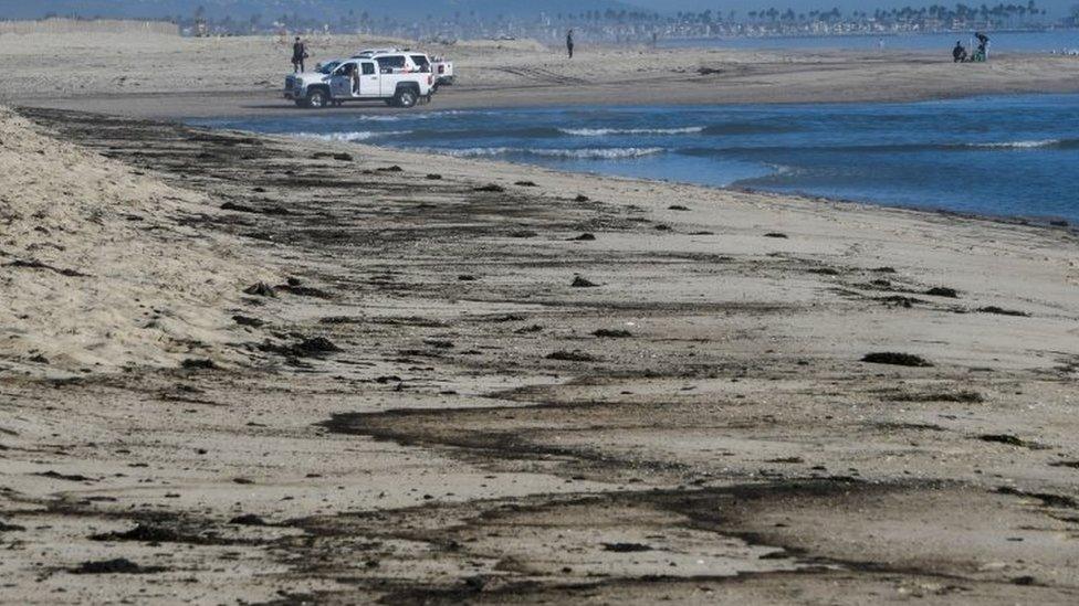 Oil stains are left behind on a beach in California