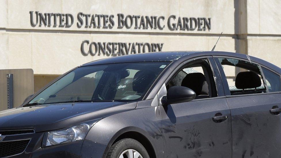 Bullet holes are visible in the windscreen of the suspect's car