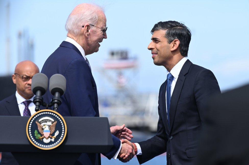 Joe Biden and Rishi Sunak shake hands